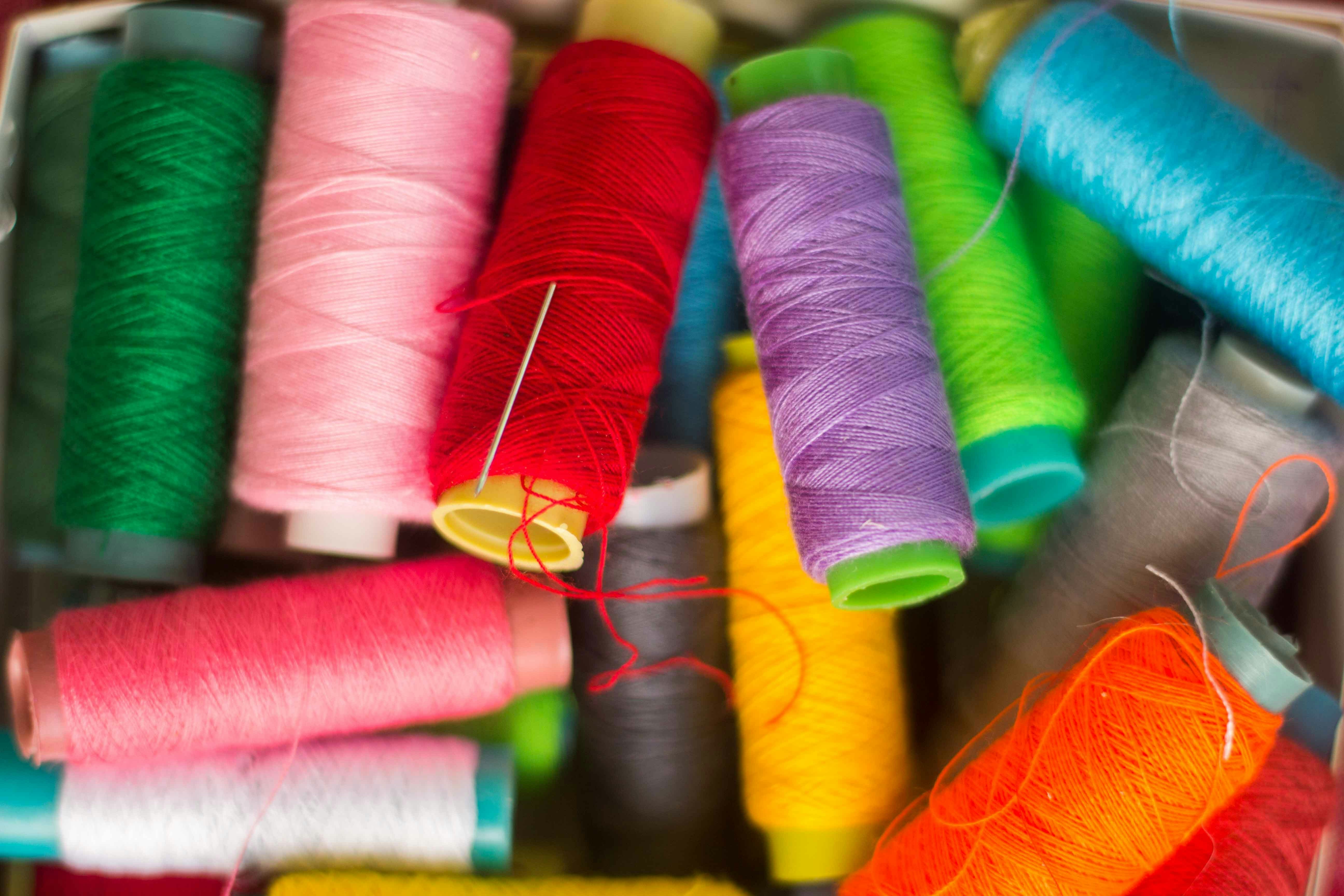 Pile of multicolored spools of thread