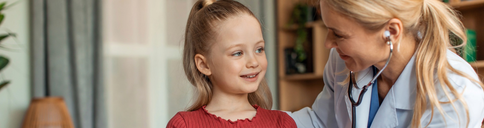 Doctor smiling at a child.