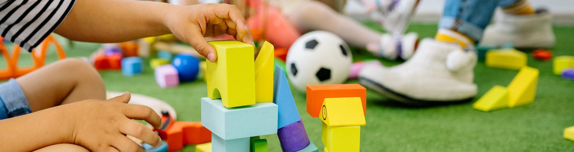 Child playing with colorful building blocks